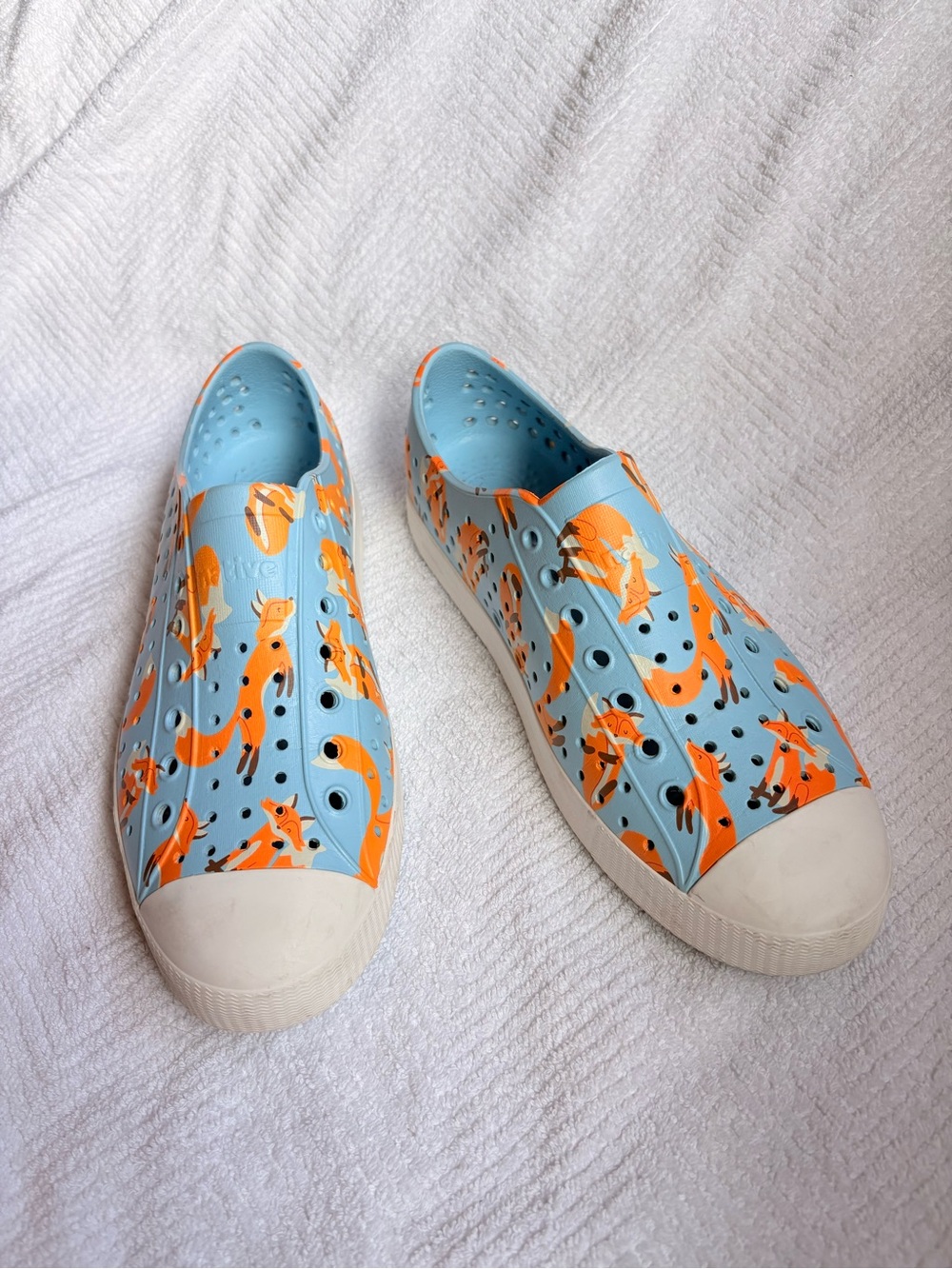 Native Shoes women’s Light Blue Slip-Ons with Orange Fox Pattern